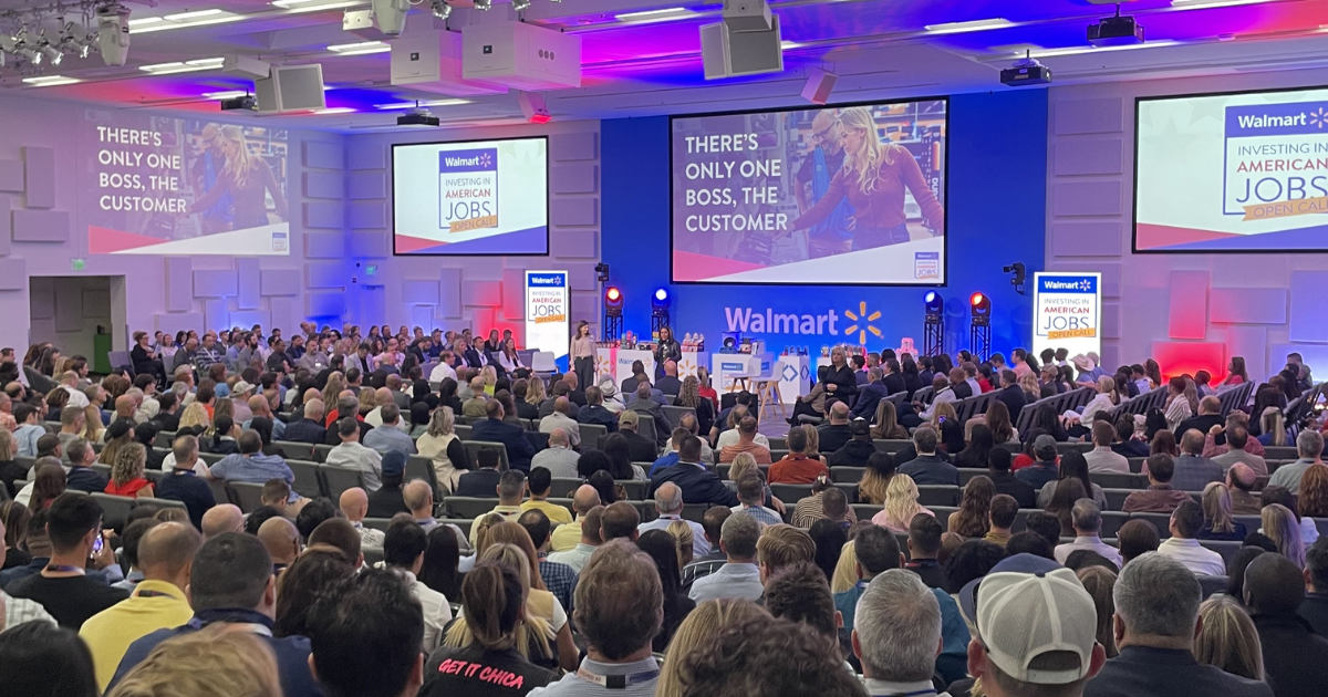 A motivational poster at Walmart Open Call with the visible text 'THERE'S ONLY ONE BOSS, THE CUSTOMER' and 'Walmart INVESTING IN AMERICAN JOBS'.