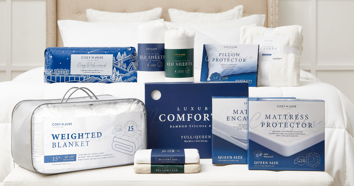 A variety of Cozy House bedding products laid out on a made bed, including sheets, pillow protectors, a weighted blanket, and a mattress protector.