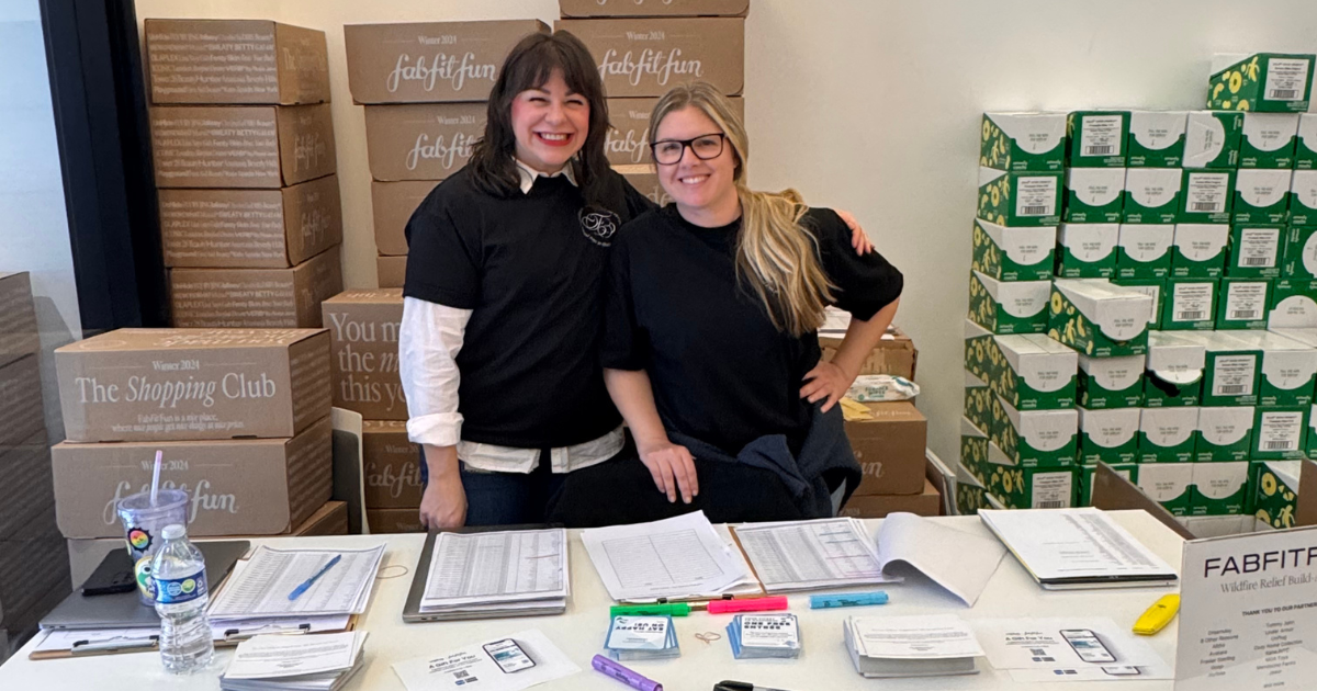 workers from FabFitFun working a table at their Build-a- Box Event